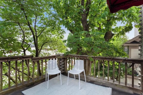 Our home's private balcony with string lights & patio seating, covered by gorgeous old trees - balcony overlooks downtown Fayetteville as our place is on the second floor.