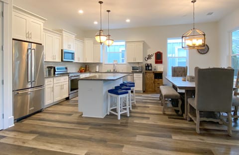 Large chef kitchen with seating for 13 and 3 more at high top table.