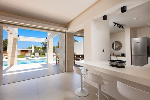Lower floor kitchen with access to the pool terrace.