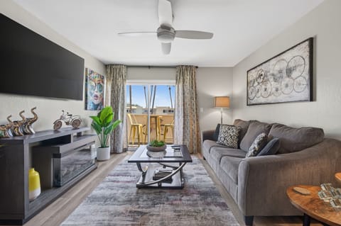Living room with 65"smart TV  overlooking the pool & green area