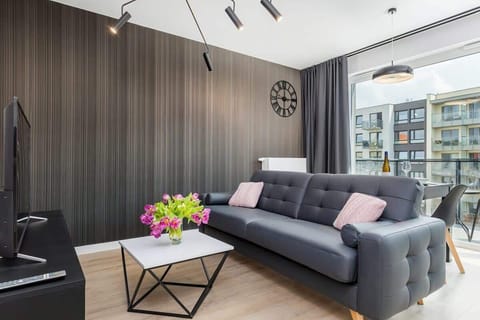 The elegant living area featuring a comfortable grey sofa perfect for relaxation.