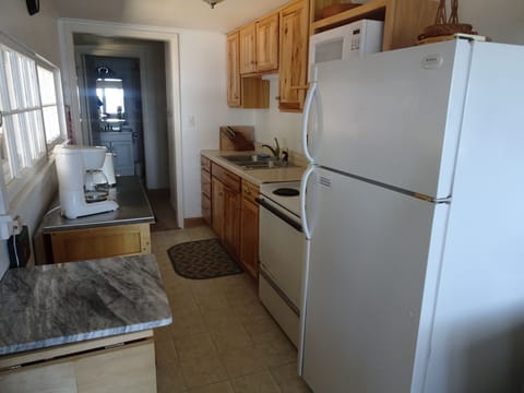 Kitchen view from dining area. Dining table seats 6.