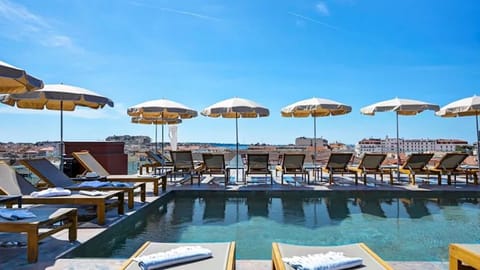 Seasonal outdoor pool, open 10:00 AM to 9:00 PM, pool umbrellas