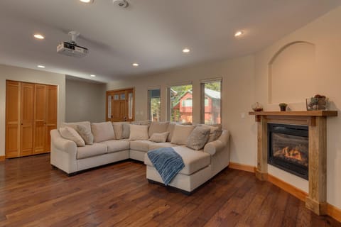 - Cozy living room with plush sectional seating  
- Warm up by the fireplace after outdoor adventures  
- Home theater projector creates a cinematic escape