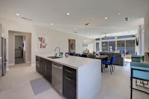 The fully-equipped kitchen features a large single bowl sink and stunning stainless steel appliances