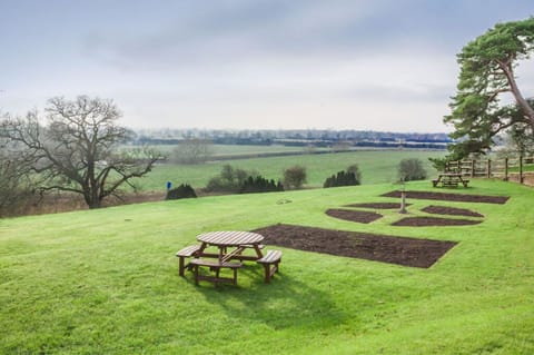 An expansive lawn with a picnic table, offering a scenic spot for outdoor dining and relaxation.
