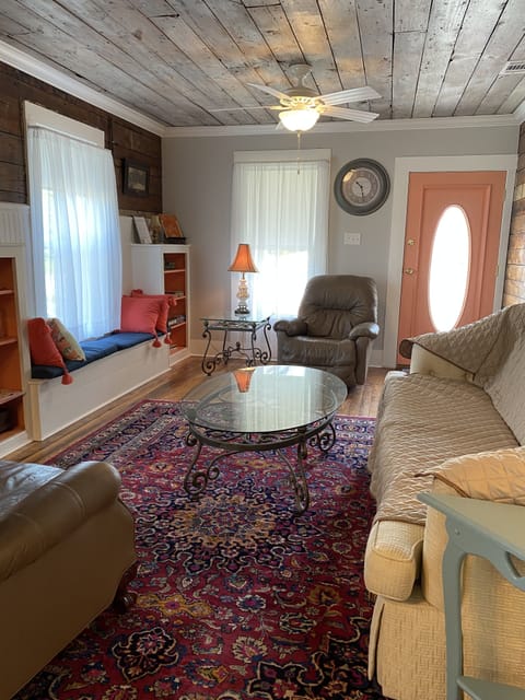 Living room has two comfortable leather recliners and large sleeper sofa