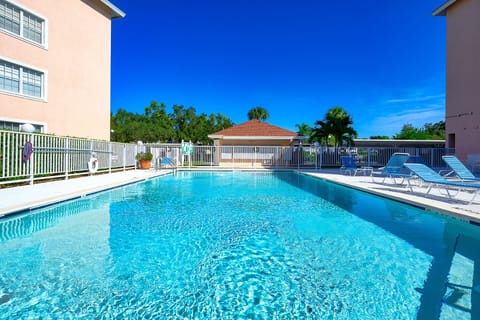 The community pool looks out to the golf course - peaceful &  lush tropical view