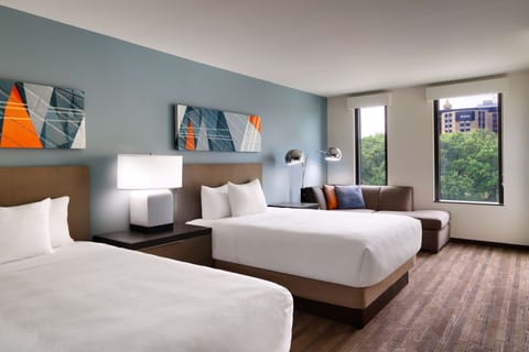 Premium bedding, desk, laptop workspace, blackout drapes