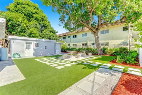 Outdoor dining area beside a neighboring shade tree