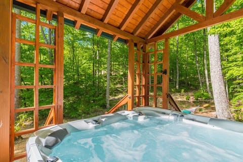 A 96-jet hot tub in its own pergola overlooking the valley steps from Bearadise!