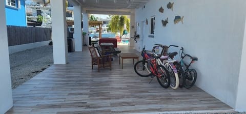 view when enter property, shaded area with pool and dinning table.