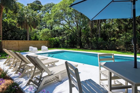 Lounge poolside in your private backyard oasis