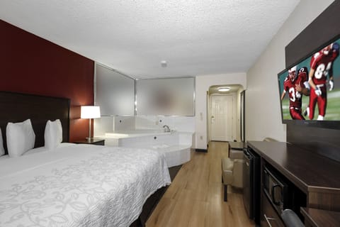 Premium Room, 1 King Bed, Jetted Tub (Upgraded Bedding & Snack, Smoke Free) | Premium bedding, desk, laptop workspace, blackout drapes