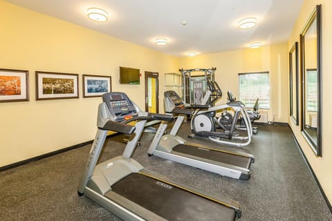24-hour fitness center with treadmills, elliptical, and recumbent cycle — no need to break your routine
