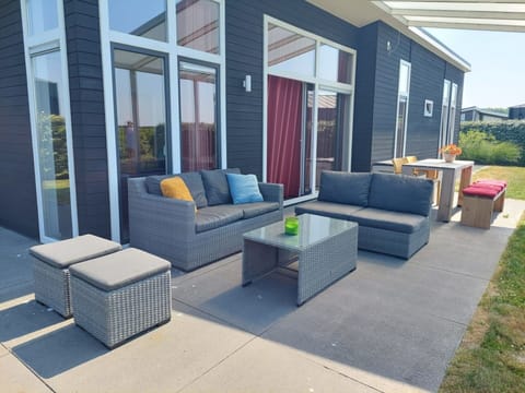 Property, Furniture, Couch, Shade, Interior Design, Outdoor Furniture, Studio Couch, Plant, Living Room, Building