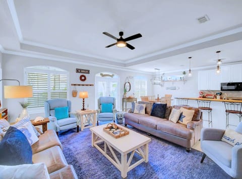 Open Living Area: Cozy seating with a smart TV and coastal decor.