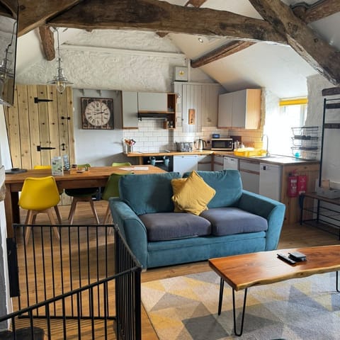 Open plan living space with log burner at The Cowshed