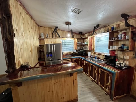 New kitchen with live edge wood epoxy cabinets and counters plus lighting!