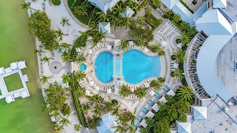 Resort pool with cabanas & palm trees 🌞 — available for all guests (not a private pool).