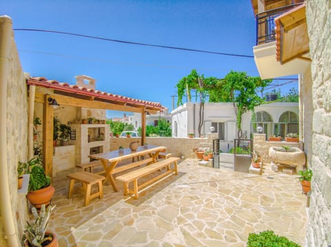 Exterior dining area with barbecue.