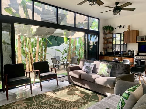 Open floor living with windows to the outdoor patio