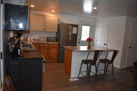Kitchen and bar seating area
as seen from the left of the entry doors.