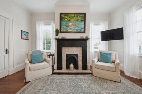 The living room is spacious and inviting, featuring comfortable seating, a flat-screen TV, and plenty of natural light. It's the perfect spot to relax and unwind after a day of exploring.