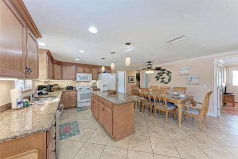 Your spacious kitchen and dining area features granite countertops, warm wood cabinets, and seating for eight—perfect for gathering.