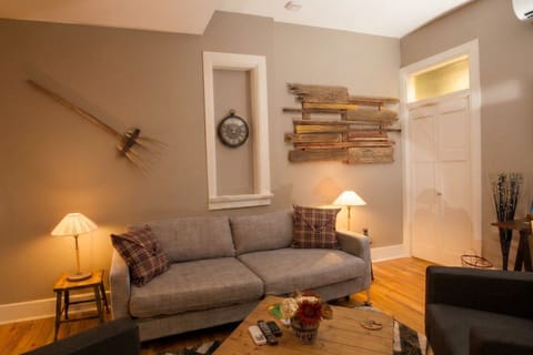 Sofa bed rests under original historic window frames
