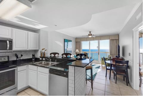 Your fully equipped kitchen opens to breathtaking ocean views, perfect for morning coffee while watching the sunrise over endless blue waters.