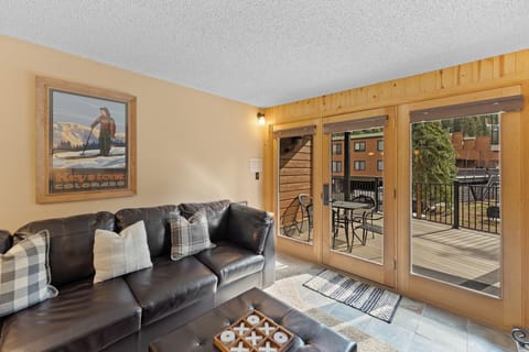 Sink into your private leather sofa and enjoy mountain views through sliding doors that open to your spacious balcony.