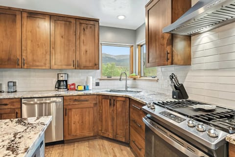 Kitchen: Main floor, drip coffee maker, Keurig, toaster, cooking utensils, tableware