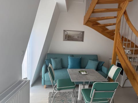 A cozy living room with a staircase leading to an upper floor.