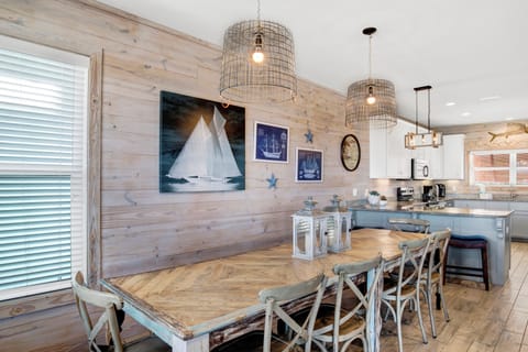 The dining table seats 10 with additional seating at the kitchen bar