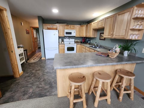 Modern kitchen amenities with ample supply of cookware and dishes