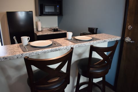 Full-size fridge, microwave, coffee/tea maker, cookware/dishes/utensils