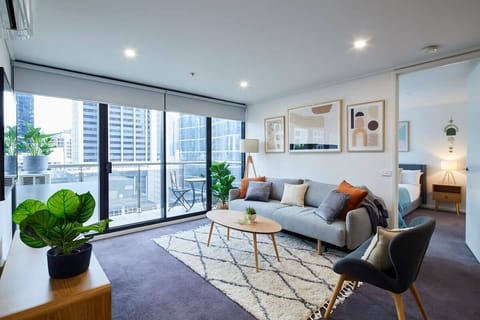 Open plan living dining room flows onto balcony with sliding doors