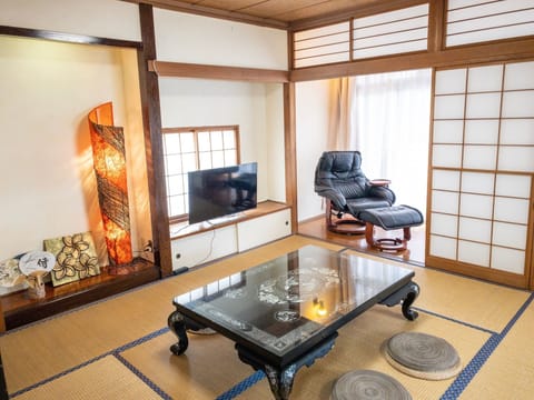Spacious Japanese Tatami room used as living room with 'Engawa' which is facing the balcony. You can enjoy television (Netflix) here.
