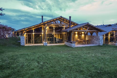 Back of chalet with panoramic windows, patio and private BBQ