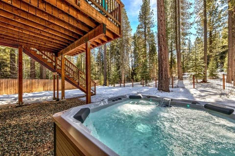 Soak in bubbling warmth surrounded by towering pines and fresh snow—your perfect winter retreat awaits.