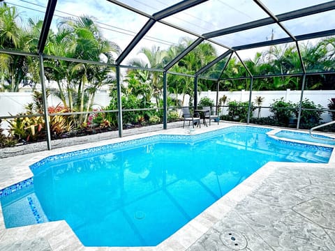 Large screened heated pool, spa and deck area.