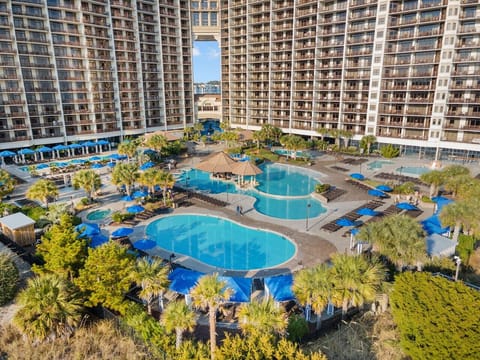 2.5-acre pool plantation featuring water parks, lazy river, numerous pools, plenty of space for sunbathing and swim-up bars.