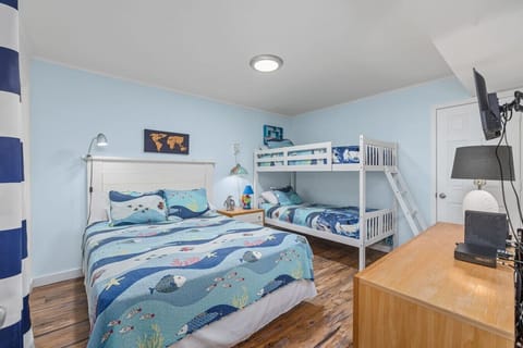 Our bunk room offers twin bunk beds, a queen bed, and cable TV, perfect for accommodating multiple guests.`