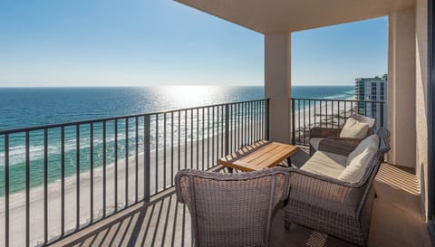 Relax on the balcony with comfortable seating and enjoy expansive views of the tranquil waters and shoreline