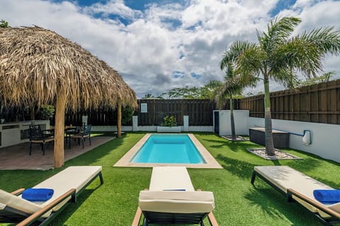 Relaxing backyard retreat featuring a refreshing pool and comfortable lounge chairs.