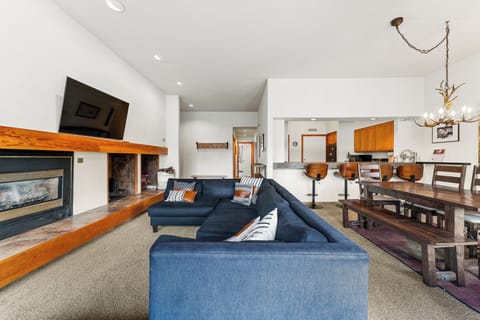 Unwind on your plush sectional by the warm fireplace, while the open kitchen awaits your culinary adventures in this inviting mountain retreat.