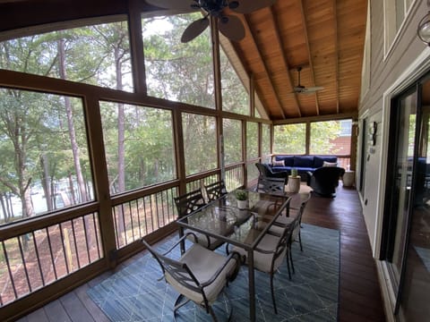 Spacious screened porch with room for relaxing and meals.