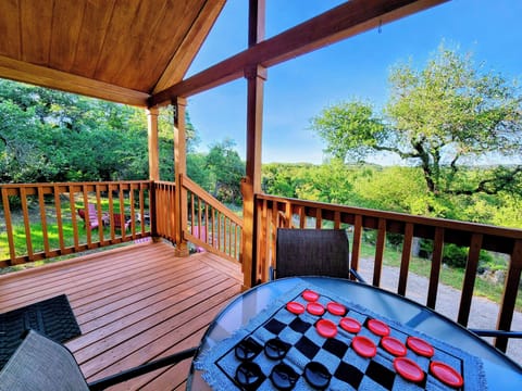 Porch with outdoor dining and view