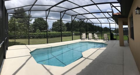 Screened-in Private Pool with view of Golf course across the street.